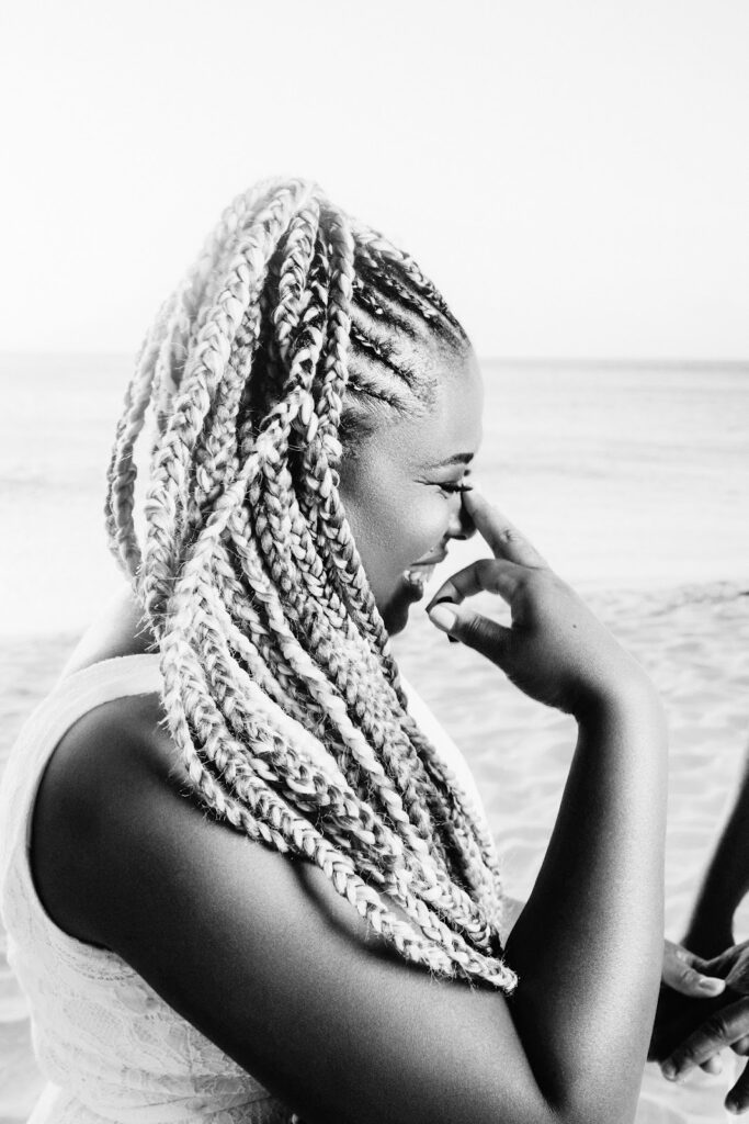 African-American female crying during surprise Aruba engagement on Eagle Beach in Aruba.